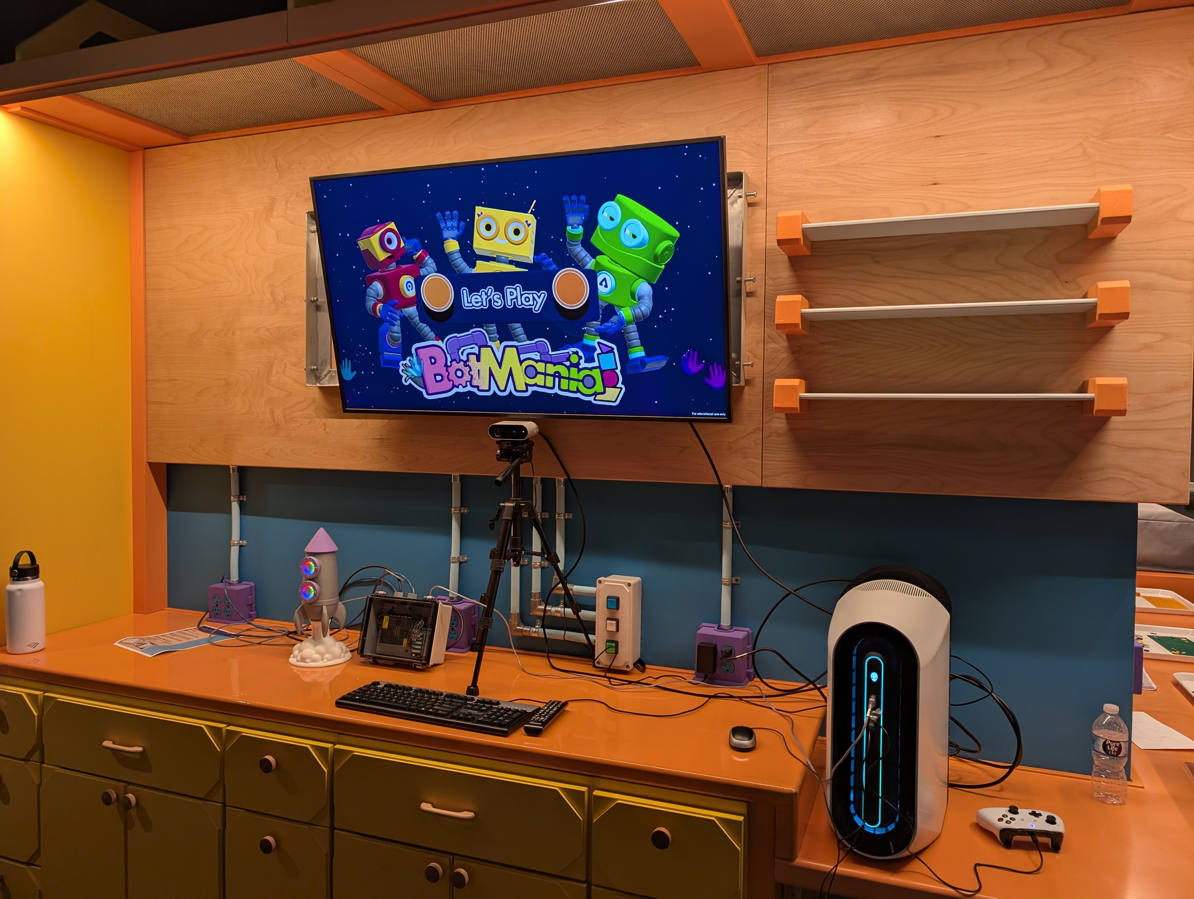 BotMania installation setup with interactive rocket, camera, and computer